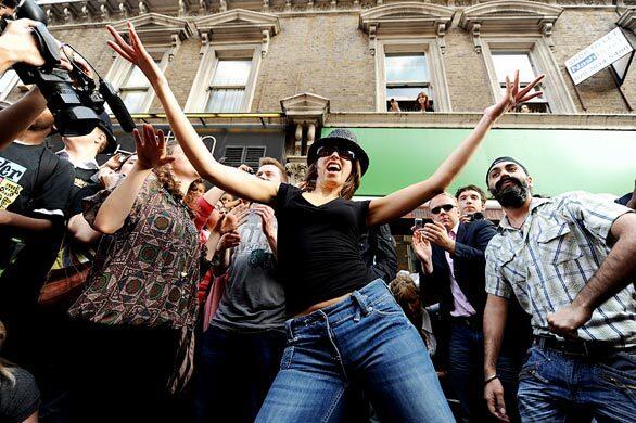 Flash mob dancers perform in London to music by Michael Jackson.