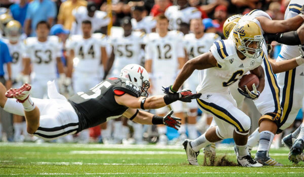 UCLA running back Jordon James gets past Nebraska defensive back Nathan Gerry during the Bruins' 41-21 victory on Saturday.