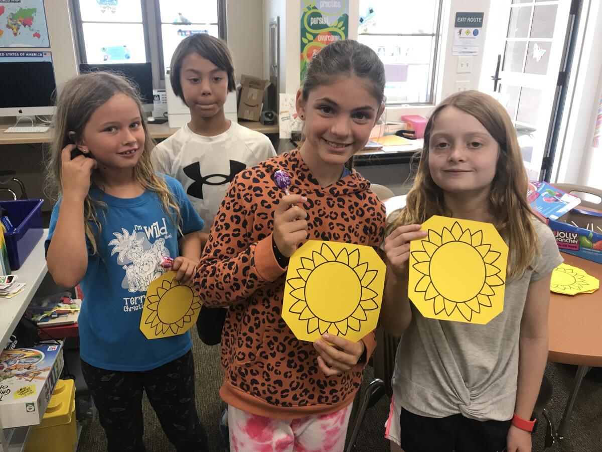 Rowe students with sunflowers.