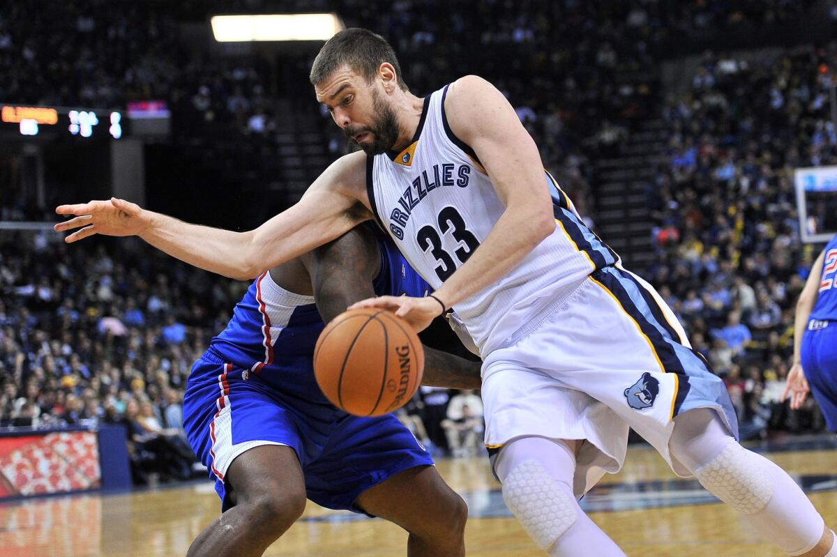 Grizzlies center Marc Gasol tries to spin to the basket around Clippers forward Glen Davis during a game on Feb. 27.