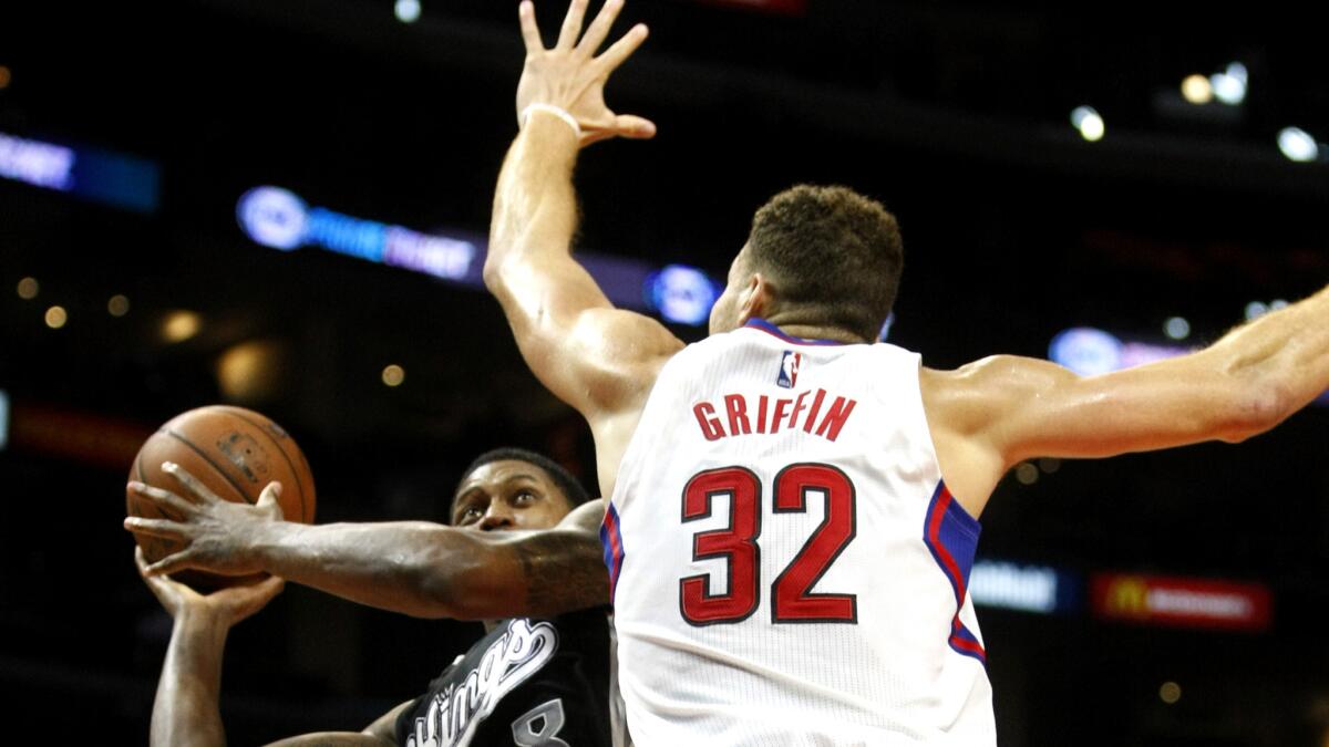 Clippers forward Blake Griffin tries to block a shot by Kings forward Rudy Gay in the second half Saturday night.