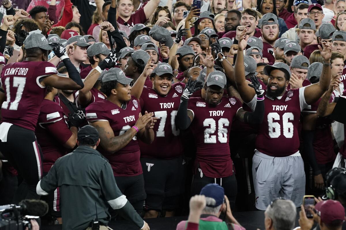 Troy players rejoice after winning the Cure Bowl on Dec. 16, 2022, in Orlando, Fla.