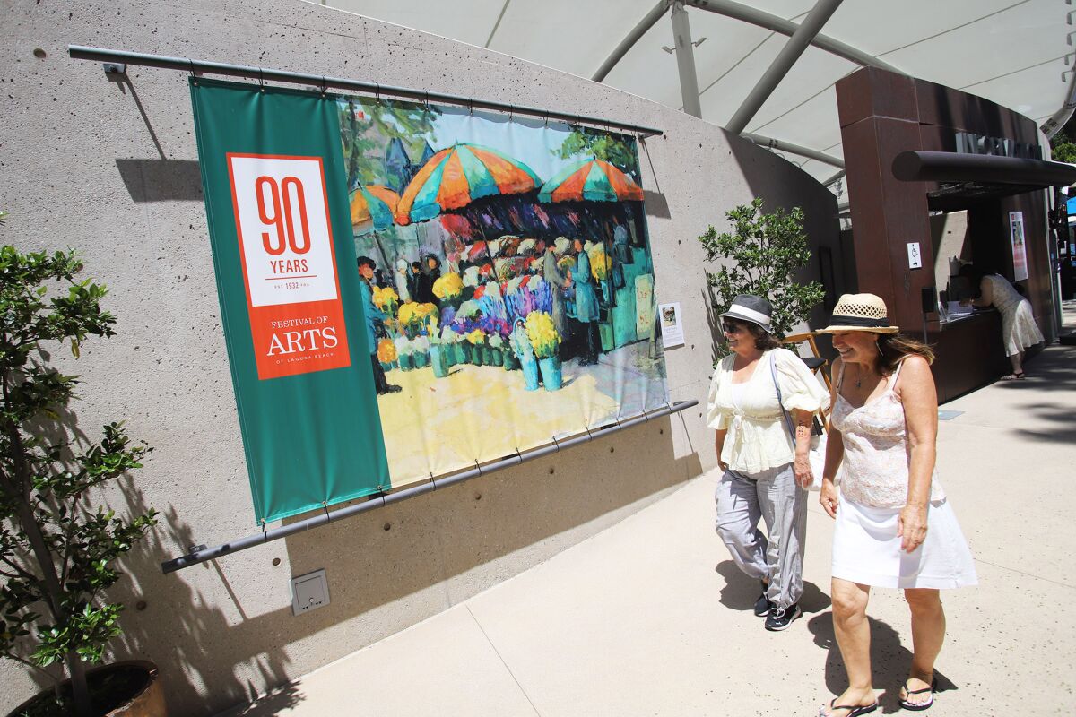 Guests browse through the Festival of Arts during the 90th anniversary celebration on Saturday in Laguna Beach.