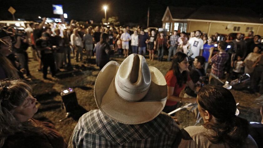 People attend a vigil in Sutherland Springs, Texas, on Sunday.