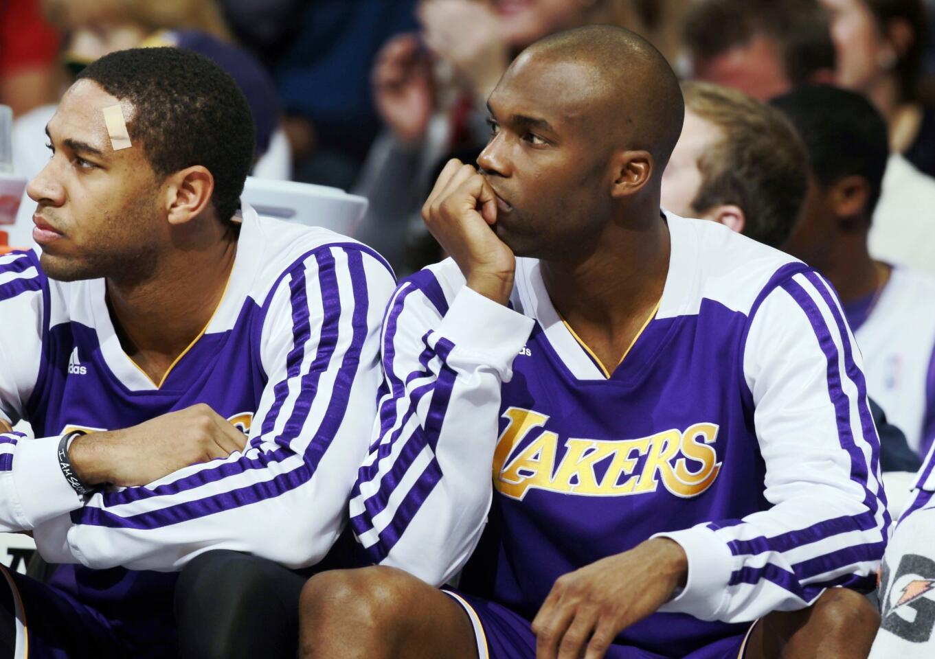 Lakers forward Xavier Henry, left, and guard Jodie Meeks watch the final seconds elapse in a 111-99 loss to the Nuggets on Wednesday night in Denver.