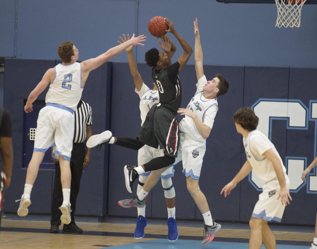 Corona del Mar High’s Mitch Haley, Dennis Rodman Jr. and John Humphreys surround Pasadena’s Bryce Hamilton in the quarterfinals of the CIF Southern Section Division 1A playoffs at Corona del Mar on Tuesday.