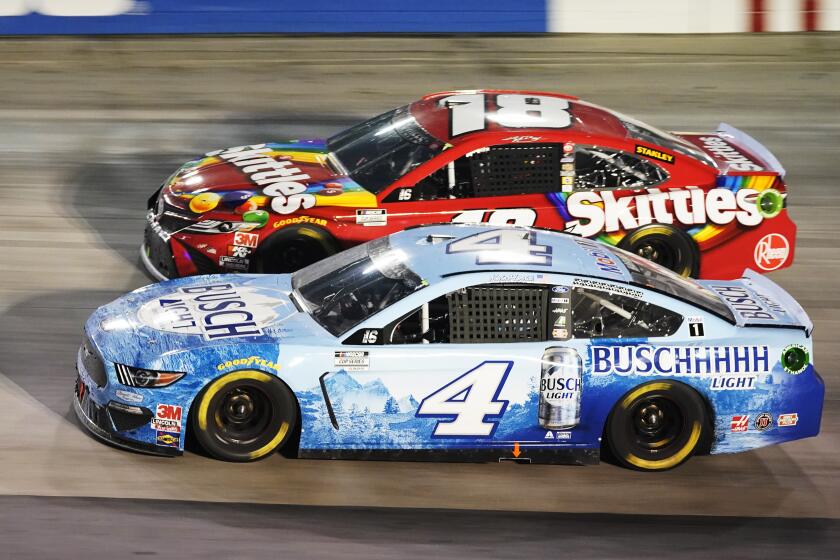 Kevin Harvick (4) passes Kyle Busch (18) during the NASCAR Cup Series auto race Saturday, Sept. 19, 2020, in Bristol, Tenn. (AP Photo/Steve Helber)