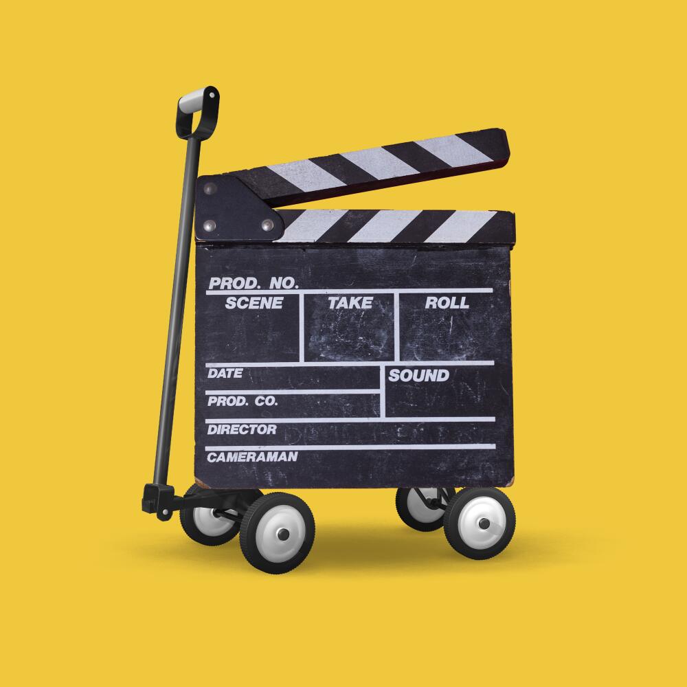 photo illustration of a TV clapper with wagon wheels and a handle