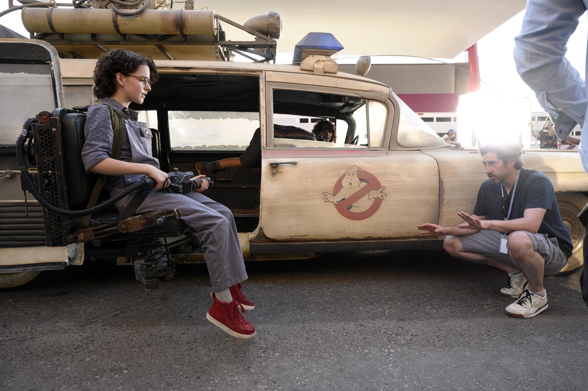 Director Jason Reitman with Mckenna Grace in the new Ecto-1 jump seat on the set of "Ghostbusters: Afterlife."