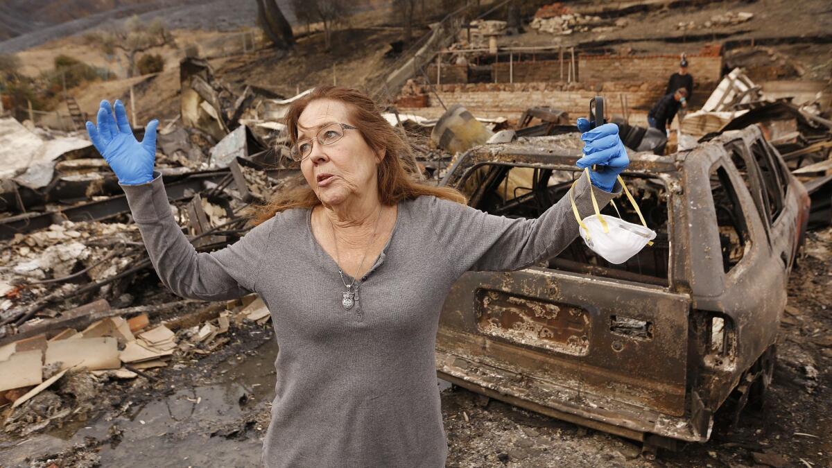 Michelle O'Wings reflects on the firestorm as she searches the rubble of her Seminole Springs home of 45 years on Nov. 13.