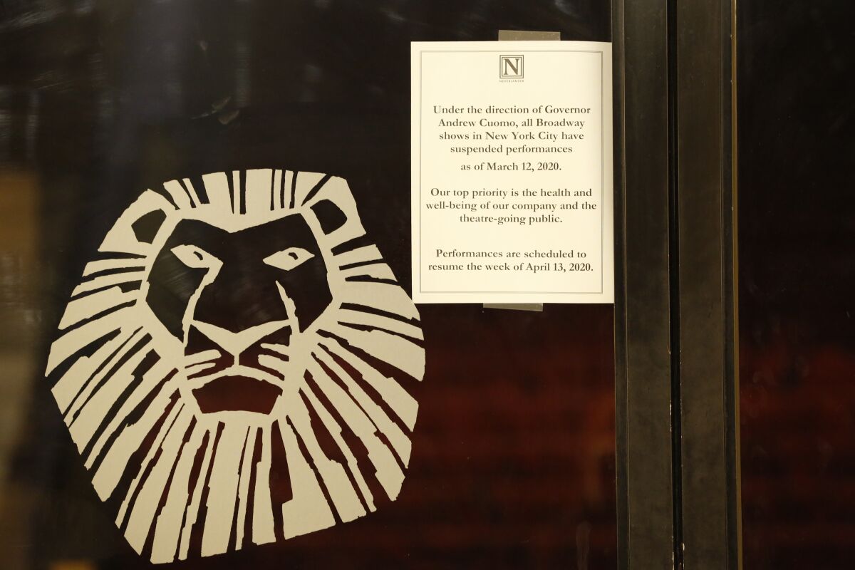 A sign announcing the suspension of all Broadway shows is posted on a door at the Minskoff Theatre, where "The Lion King" had been playing, Thursday, March 12, 2020, in New York. Gov. Andrew Cuomo banned gatherings of more than 500 people. (AP Photo/Kathy Willens)
