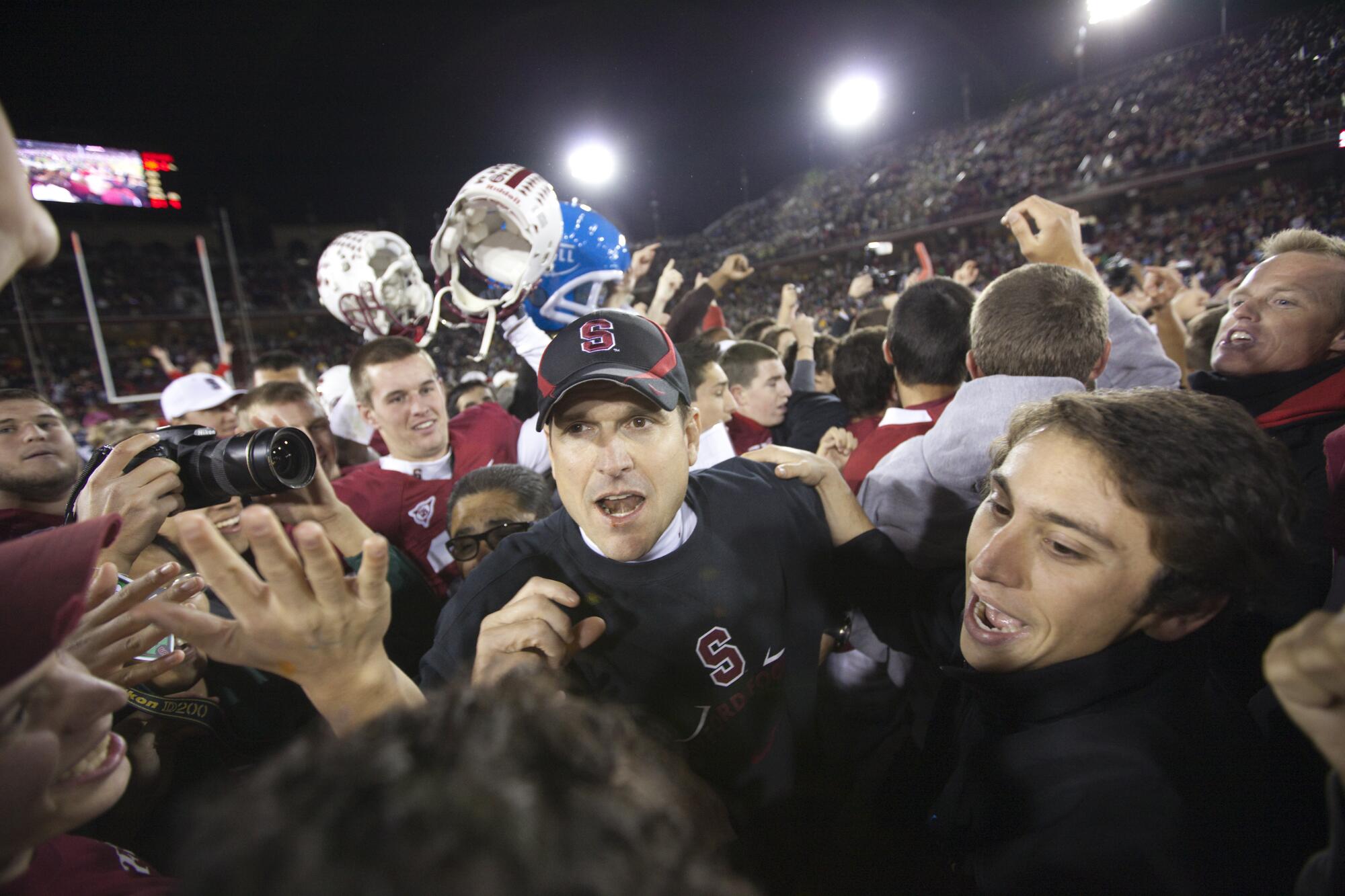 Stanford coach Jim Harbaugh celebrates following a victory over Notre Dame.