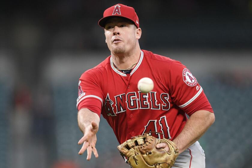 Los Angeles Angels first baseman Justin Bour (41) tosses the ball towards first during a baseball game against the Baltimore Orioles, Friday, May 10, 2019, in Baltimore. (AP Photo/Nick Wass)
