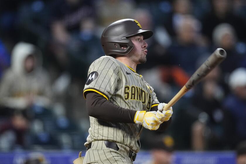 San Diego Padres' Jackson Merrill watches his RBI single against Colorado Rockies starting pitcher Ryan Feltner during the third inning of a baseball game Tuesday, April 23, 2024, in Denver. (AP Photo/David Zalubowski)