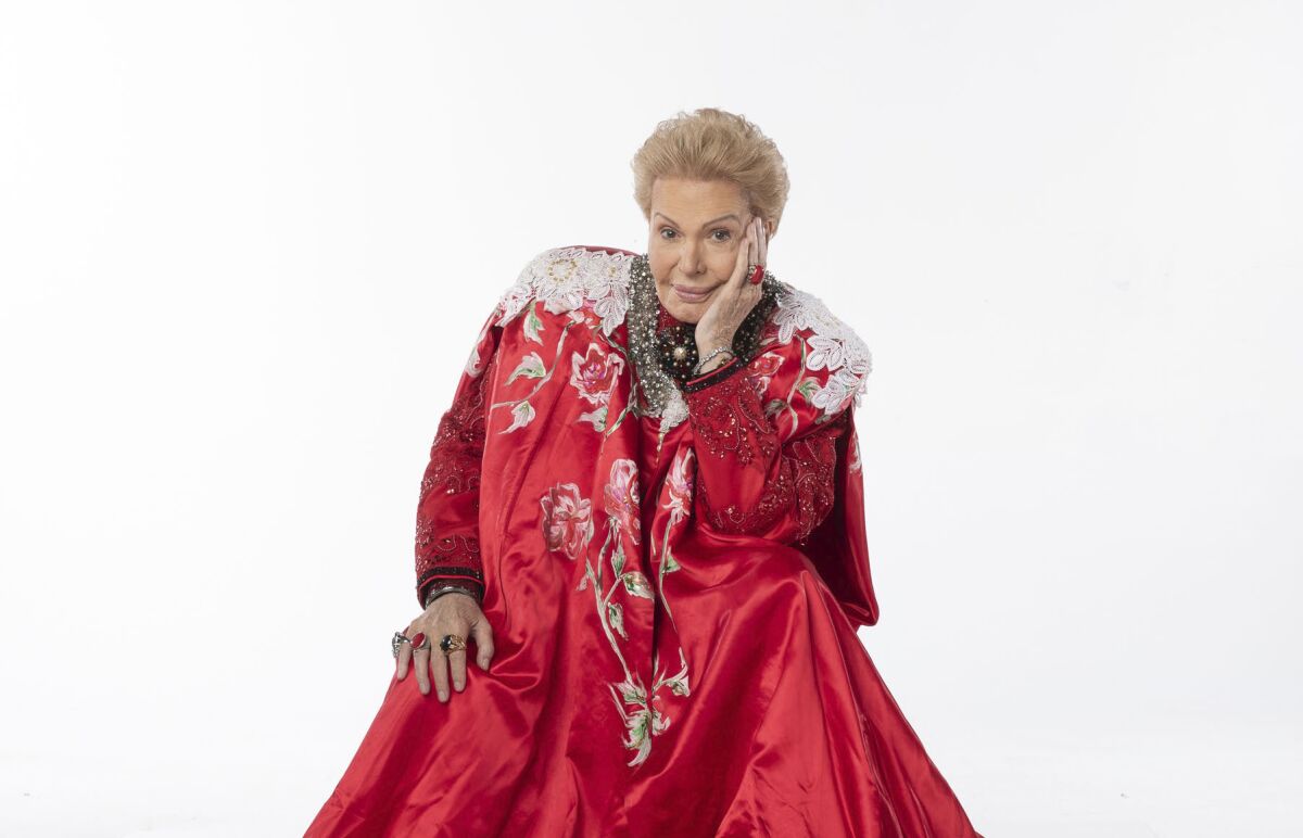 Walter Mercado in a red cape in the documentary "Mucho Mucho Amor."