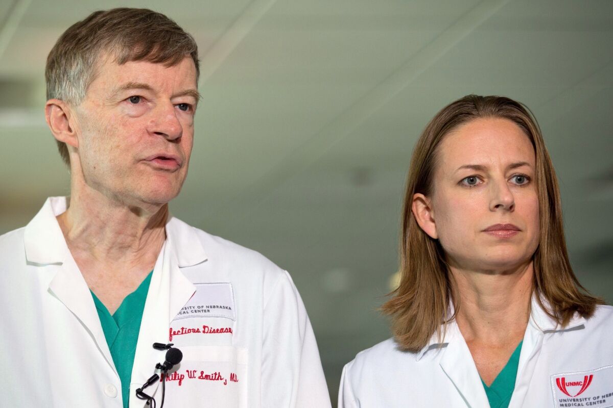 Dr. Philip W. Smith, left, and Dr. Angela Hewlett speak during a news conference Sept. 7 about the condition of Dr. Rick Sacra at the Nebraska Medical Center in Omaha on Sept. 7. Hospital officials announced this week that Sacra had received TKM-Ebola, an experimental drug from Canada.