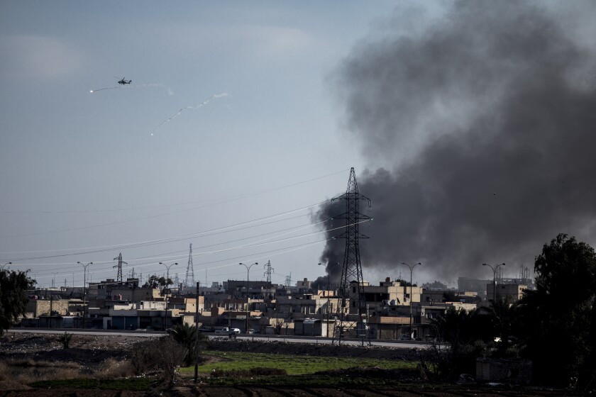US attack helicopter shoots flares in Hassakeh, northeast Syria, Wednesday, Jan. 26, 2022. Dozens of armed Islamic State militants remained holed up in the last occupied section of a Syrian prison, U.S.-backed Kurdish-led forces said Thursday. The two sides clashed a day after the Syrian Democratic Forces announced they had regained full control of the facility. (AP Photo/Baderkhan Ahmad)