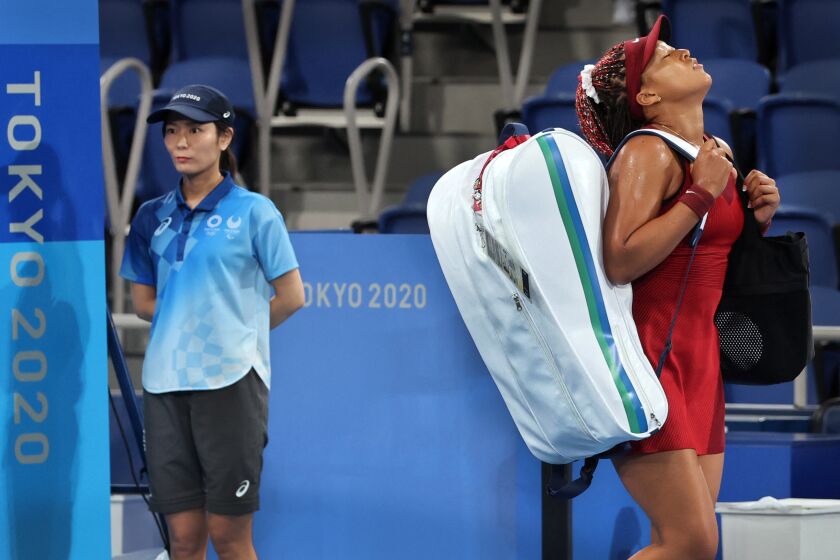 Naomi Osaka leaves the court after being beaten by Marketa Vondrousova during their Olympic tennis match