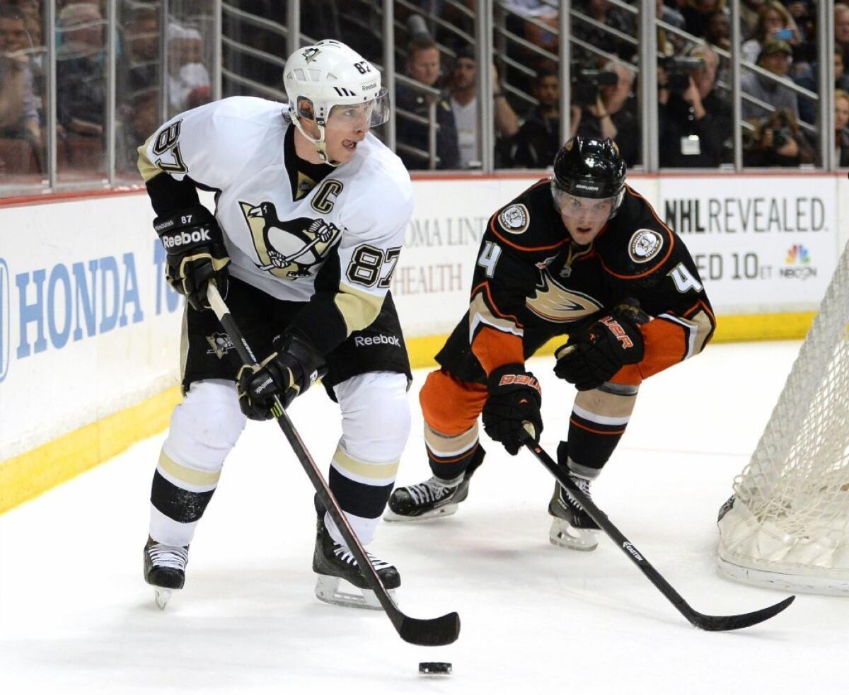 The Pittsburgh Penguins' Sidney Crosby looks to pass in front of the Ducks' Cam Fowler.