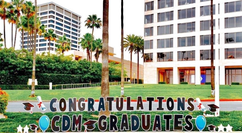 Signage congratulates graduates from Corona del Mar High School along the drive-by route on Saturday.