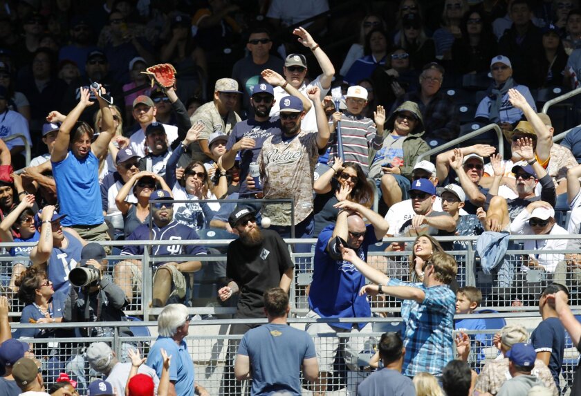Fans go for a foul ball during the Padres-Dodgers game at Petco Park.