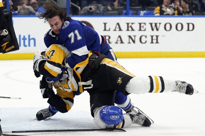 Tampa Bay Lightning center Anthony Cirelli (71) takes down Pittsburgh Penguins right wing Bryan Rust (17) as they battle during the second period of an NHL hockey game Thursday, March 3, 2022, in Tampa, Fla. (AP Photo/Chris O'Meara)