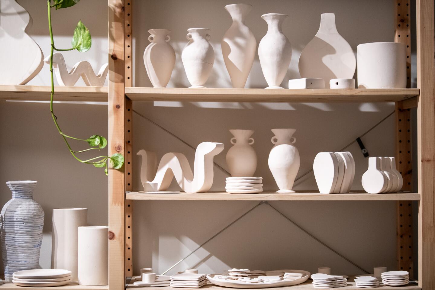 Unfinished pieces dry on shelves inside the Kreep Ceramics studio.