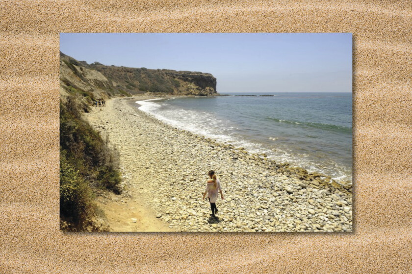 Person walking on a rocky beach at Abalone Cove.
