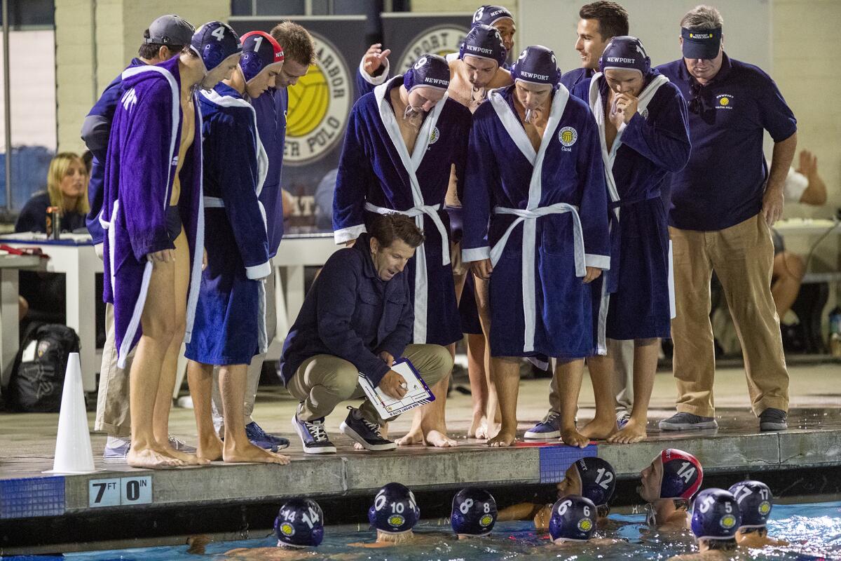 Newport Harbor's head coach Ross Sinclair gives instructions to his team during the Battle of the Bay rivalry match.