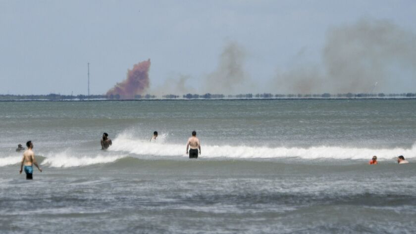 A cloud of orange smoke rises over nearby Cape Canaveral Air Force Station as seen from Cocoa Beach, Fla., Saturday, April 20, 2019. SpaceX reported an anomaly during test firing of its Dragon 2 capsule.