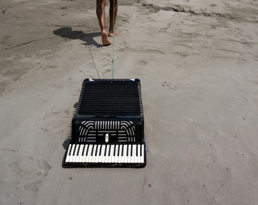 An accordion on the sand from Los Jaichackers' "Subterranean Homesick Cumbia"