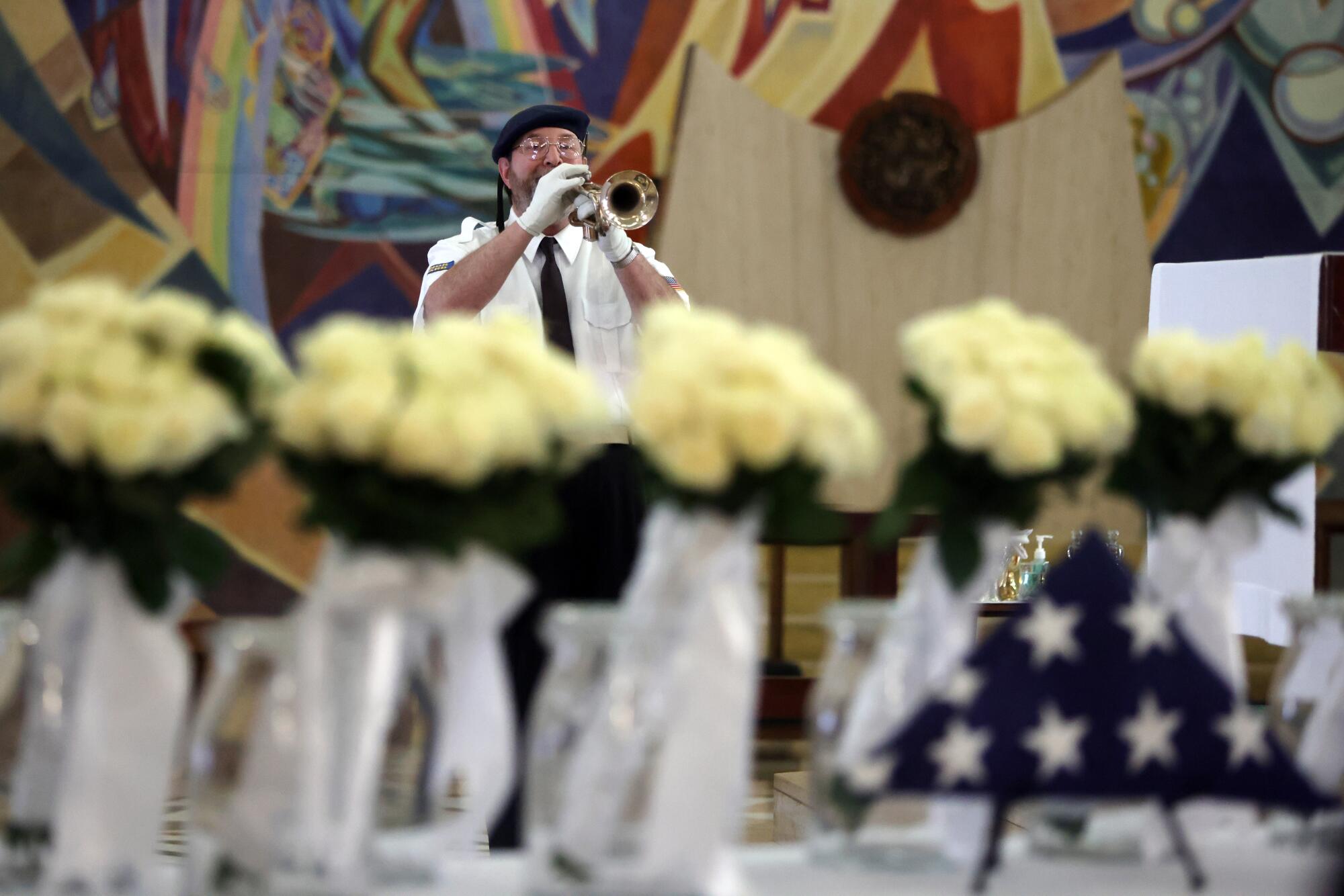 A bugler plays taps during a Memorial Day Mass.
