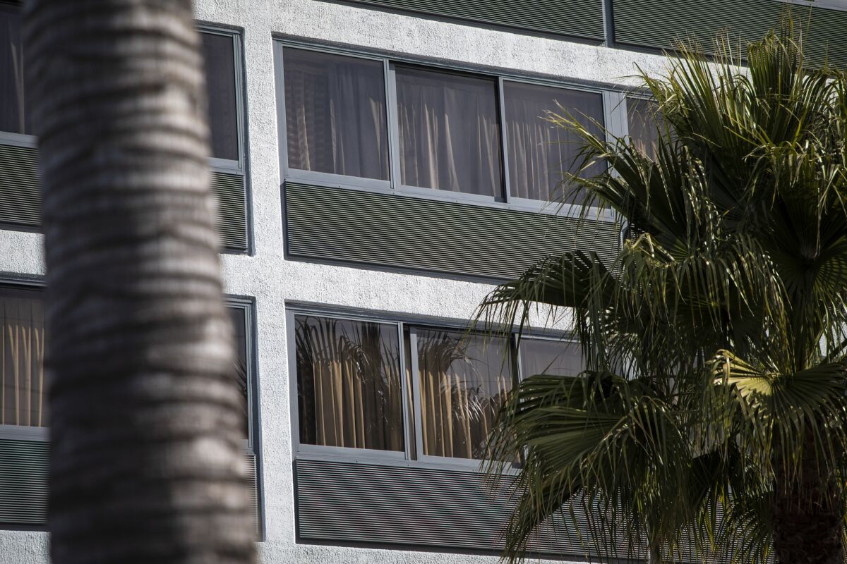The curtains are pulled shut at a hotel in Oakland on Feb. 9, 2022. Photo by Martin do Nascimento, CalMatters