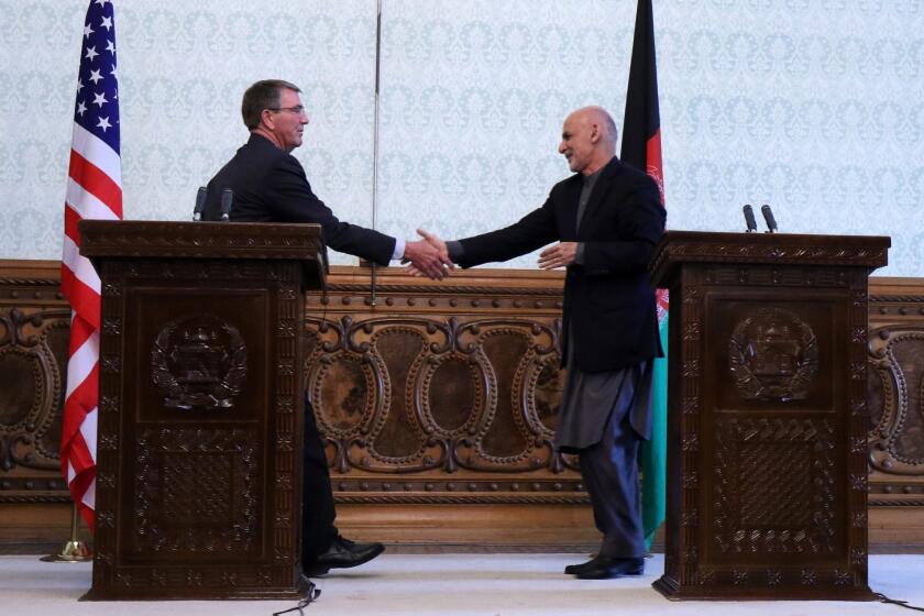 Defense Secretary Ashton Carter, left, shakes hands with Afghan President Ashraf Ghani during a news conference in Kabul on Dec. 9.