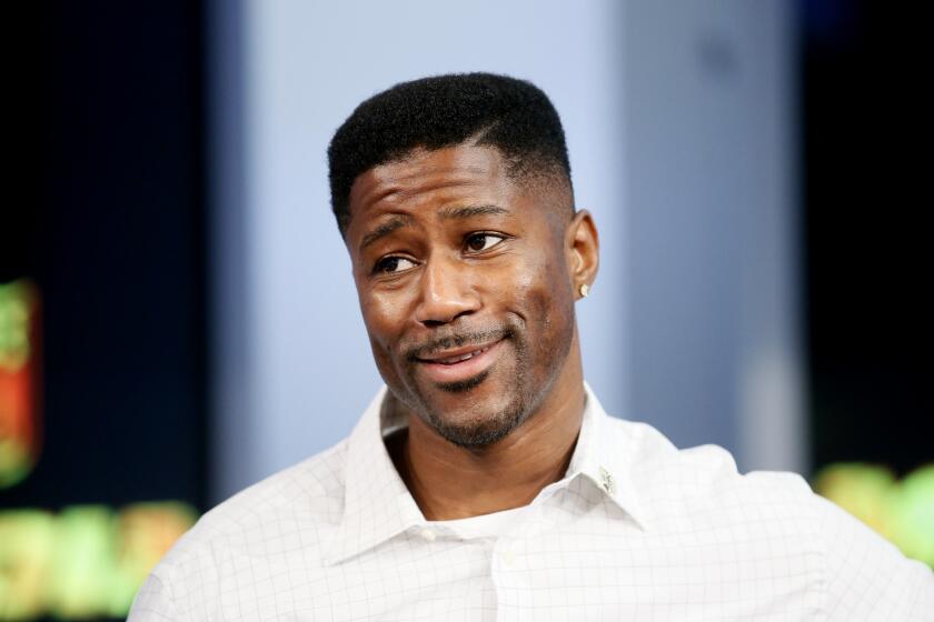 FILE - In this Sept. 9, 2015, file photo, former NFL player Nate Burleson is interviewed during a media availability on set at the at NFL Network studios in Culver City, California. CBS is making another change to its cast for the “NFL Today” show on Sundays, adding Nate Burleson to replace Bart Scott. Burleson is the second newcomer to the program, although Phil Simms is moving from the broadcast booth to the studio. That switch was announced last month. (AP Photo/Danny Moloshok, File)