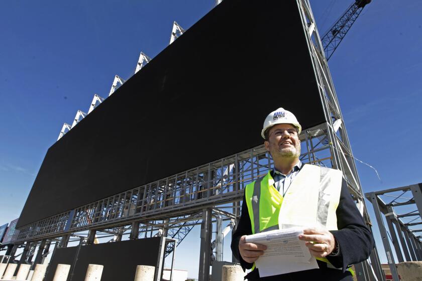 FILE - Texas Motor Speedway President Eddie Gossage gives a tour of the large television screen being constructed at the track, Feb. 14, 2014, in Fort Worth, Texas. Gossage, an old-school promoter mentored by stock car racing pioneers, has died at the age of 65, Speedway Motorsports announced Thursday night, May 16, 2024. (Ron T. Ennis/Star-Telegram via AP, File)