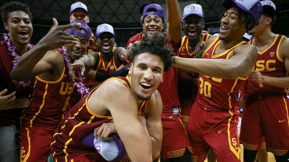 Bennie Boatwright, front, and his USC teammates enjoy themselves after winning the championship game of the Diamond Head Classic against New Mexico State on Dec. 25, 2017 in Honolulu.