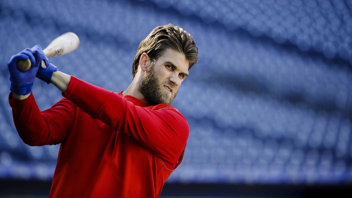 Philadelphia Phillies outfielder Bryce Harper warms up before batting practice.