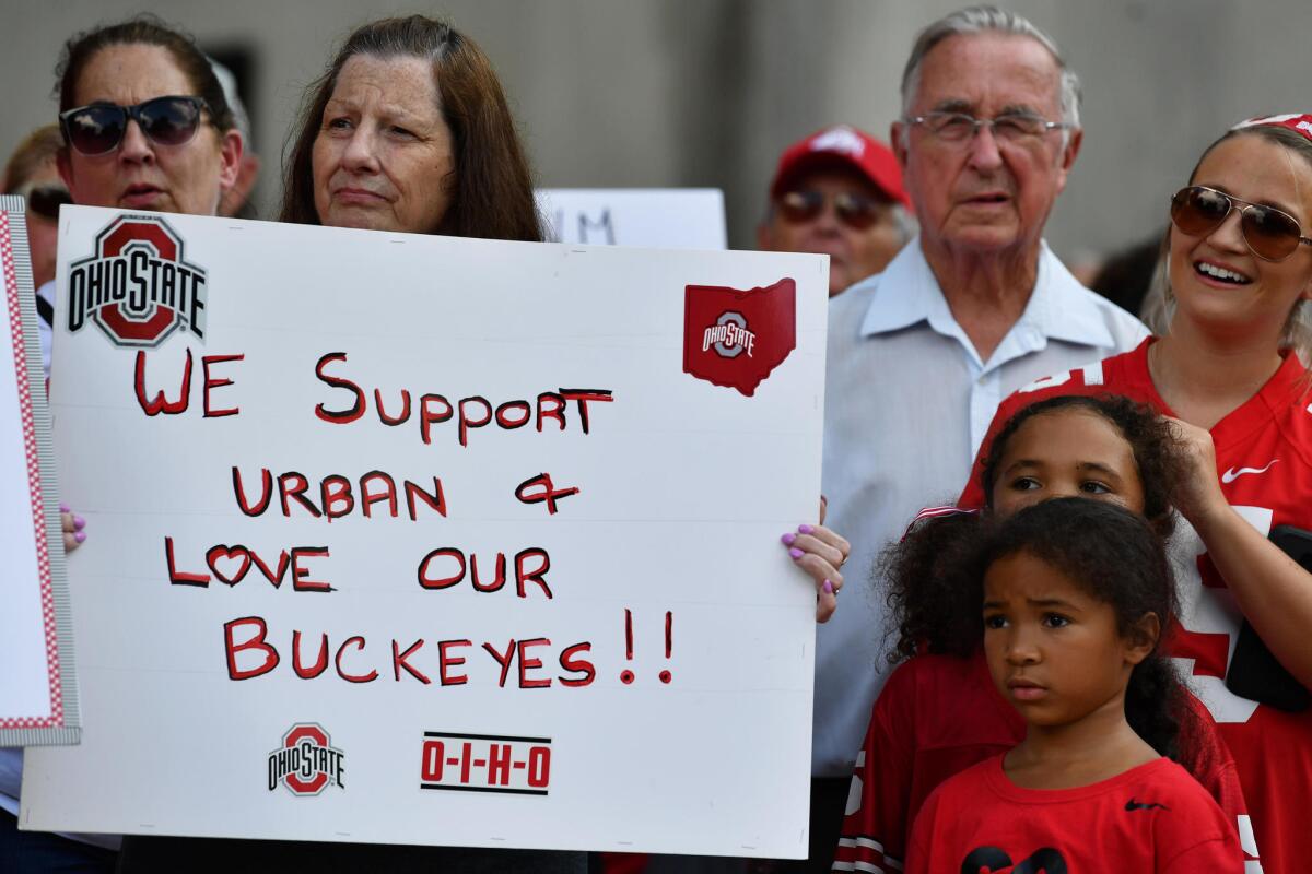 Supporters of Ohio State football coach Urban Meyer hold a rally at the university on Aug. 6.