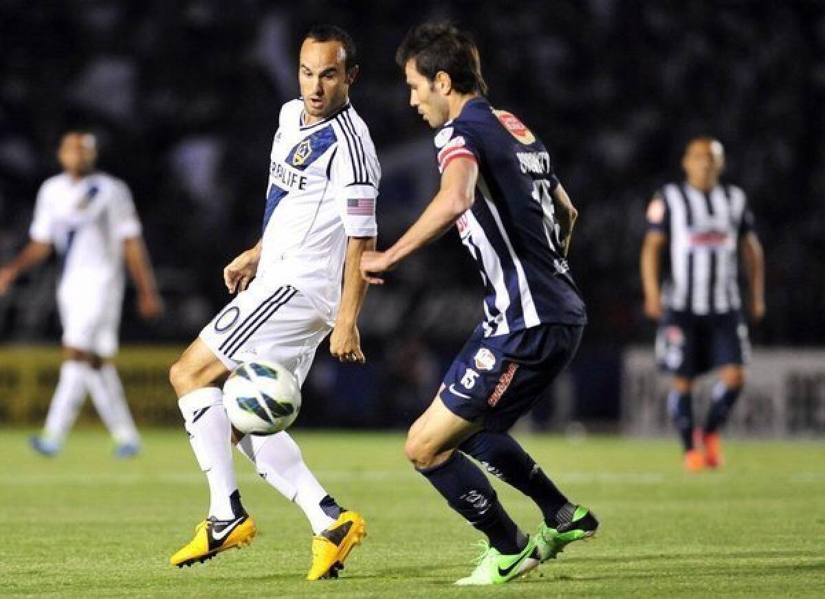 Landon Donovan, left, vies for the ball with Monterrey's Jose Basanta during a Champions League game.