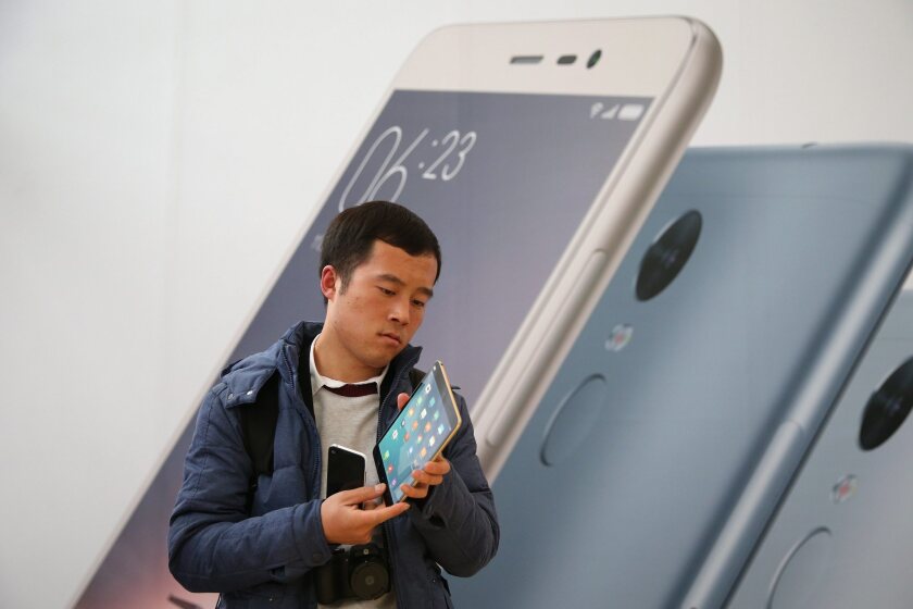 A man examines the new Xiaomi "Mi pad 2" after a Xiaomi new products releasing ceremony in Beijing in November.