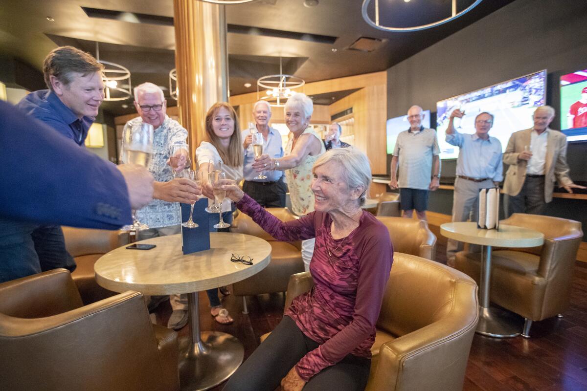 Friends and colleagues toast former Mayor Nancy Gardner, center, after they surprised her with the news that she is the Newport Beach Chamber of Commerce's 2019 Citizen of the Year.