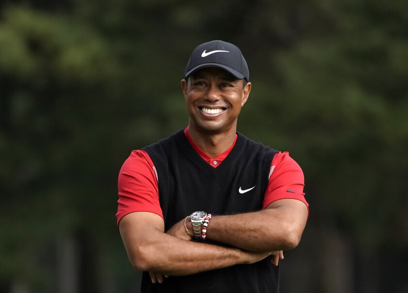 FILE - In this Oct. 28, 2019, file photo, Tiger Woods smiles during the winner's ceremony after winning the Zozo Championship PGA Tour at the Accordia Golf Narashino country club in Inzai, east of Tokyo, Japan. A man who found Woods unconscious in a mangled SUV last week after the golf star who later told sheriff's deputies he did not know how the collision occurred and didn't even remember driving, crashed the vehicle in Southern California, authorities said in court documents. Law enforcement has not previously disclosed that Woods had been unconscious following the collision. (AP Photo/Lee Jin-man, File)