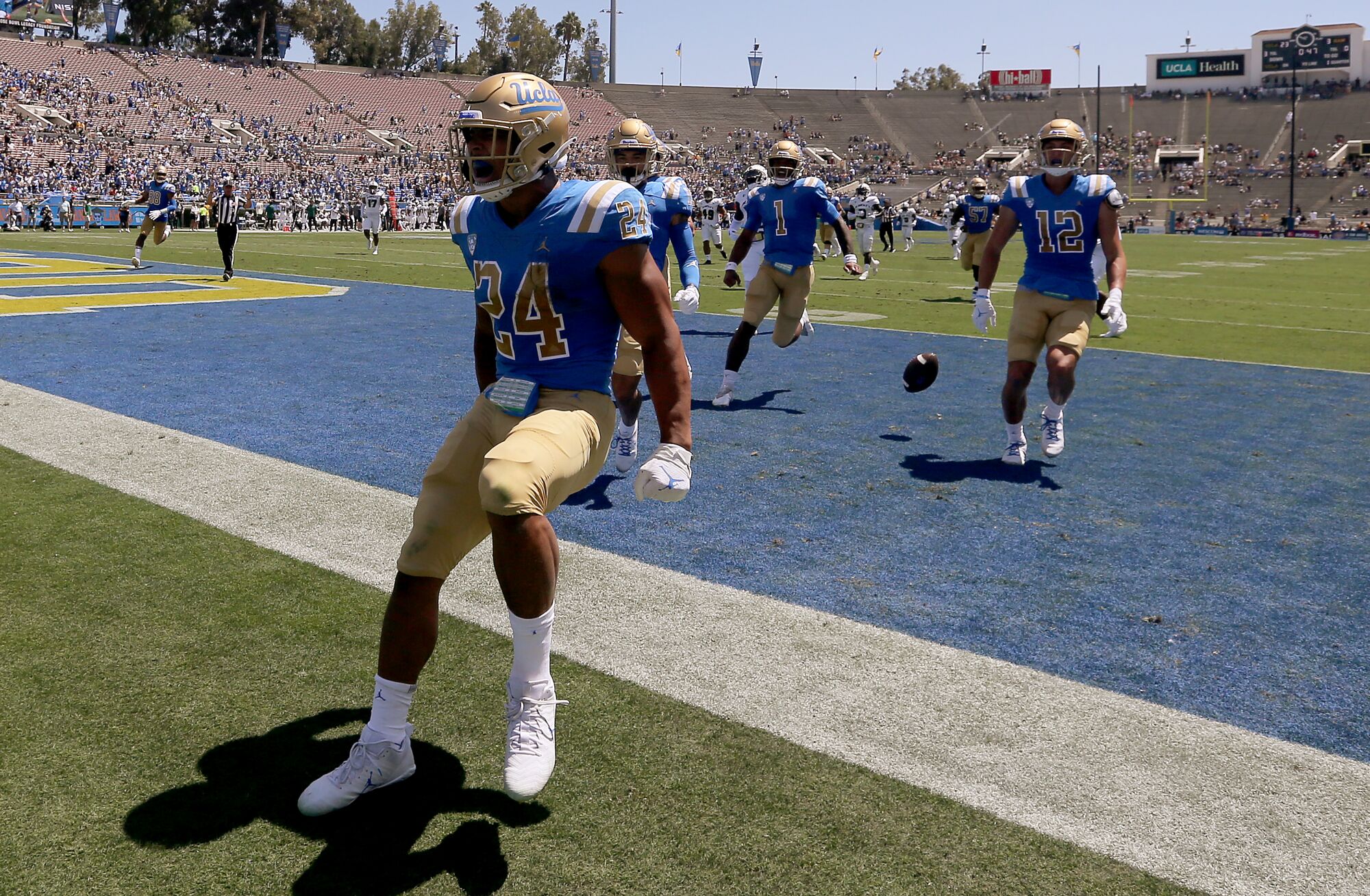 UCLA running back Zach Charbonnet celebrates after scoring a touchdown against Hawaii in the Rose Bowl.