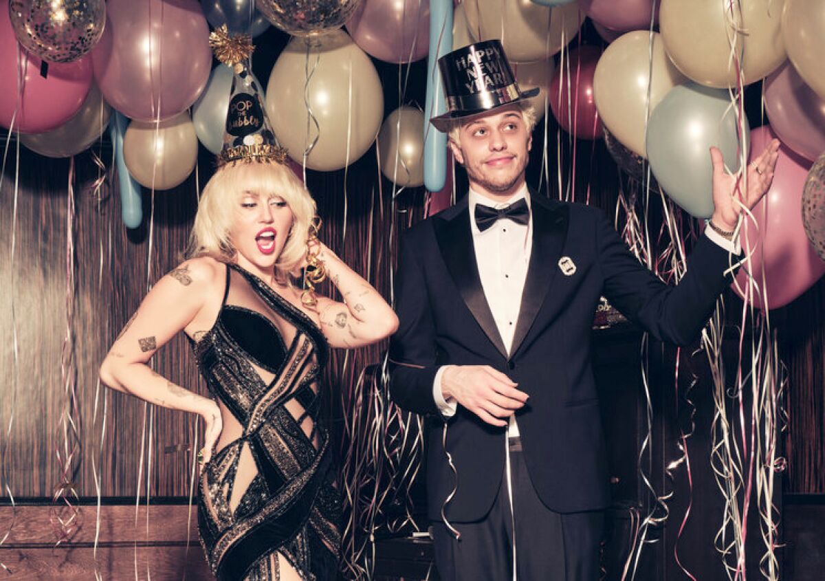 A stylishly dressed Miley Cyrus and Pete Davidson prepare to celebrate New Year’s Eve