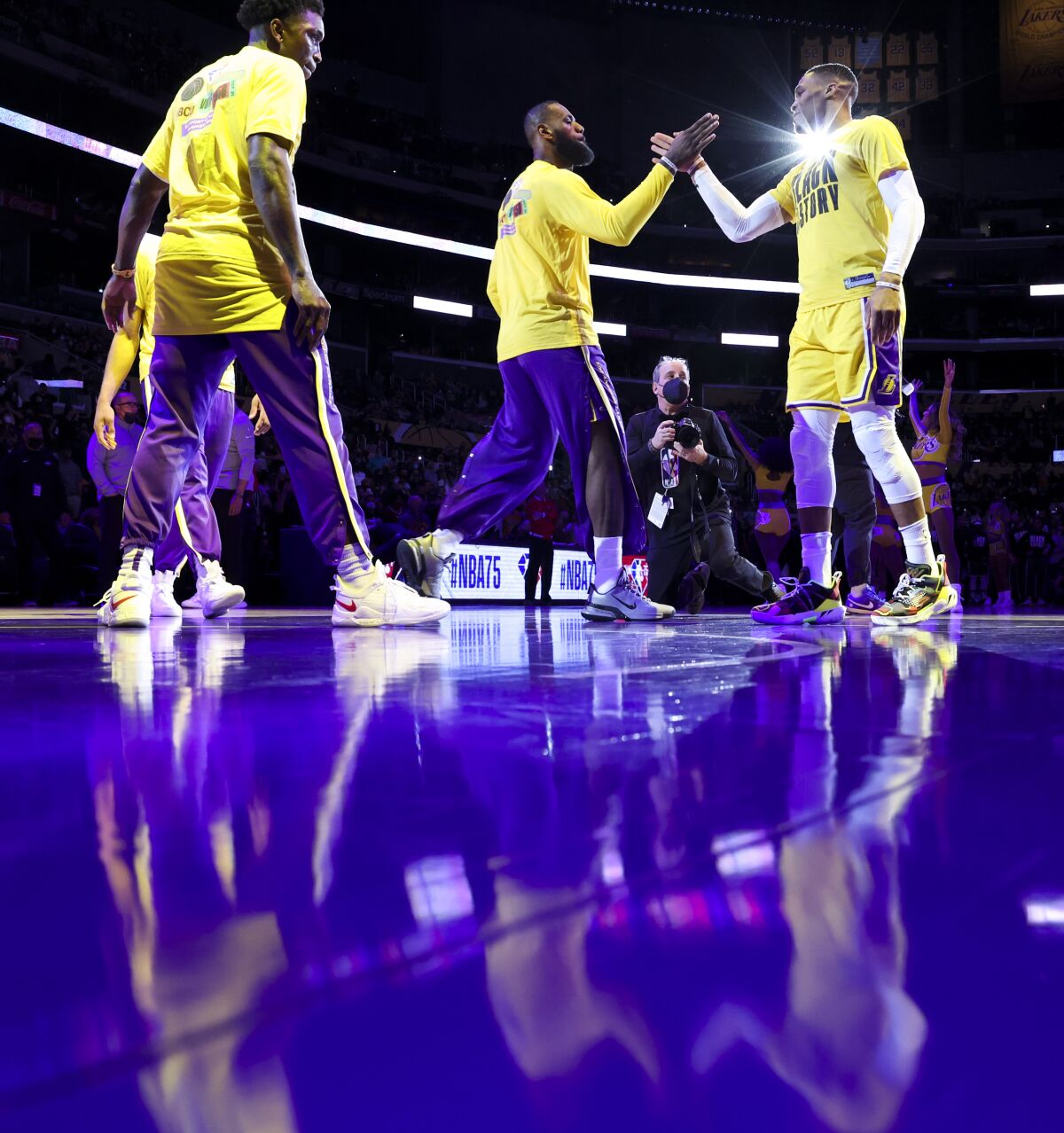 Lakers forward LeBron James slaps hands with guard Russell Westbrook while being introduced before a game.