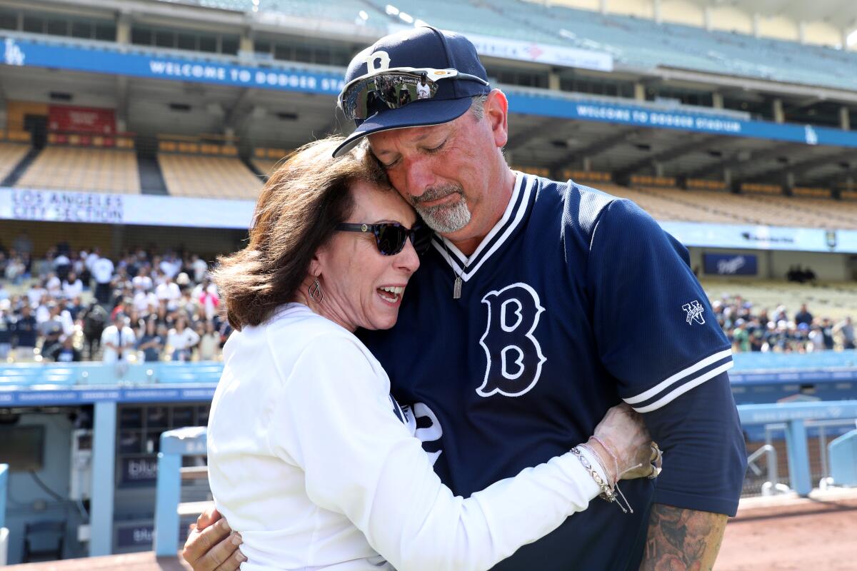 An emotional Birmingham coach Matt Mowry speaks with the mother of his late wife, Amy.