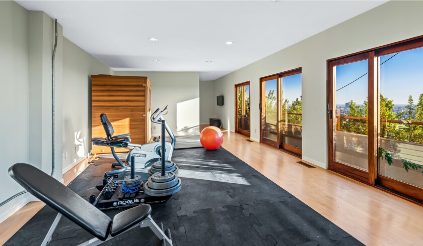 The hillside home includes three levels of decks, balconies and patios, as well as a swimming pool and spa.