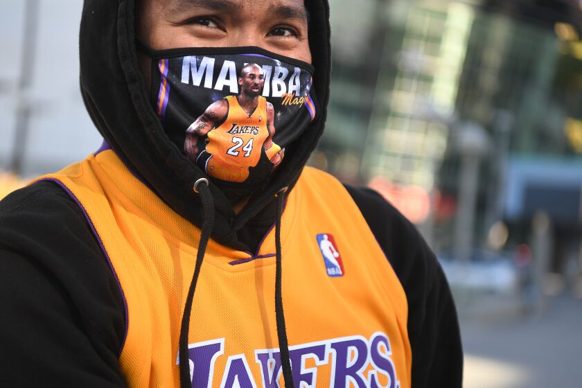 LOS ANGELES, CALIFORNIA JANUARY 26, 2021-Randolf Garrido stands outside of Staples Center on the 1-year anniversary of Kobe Bryant's death in Downtown Los Angeles Tueswday. (Wally Skalij/Los Angeles Times)