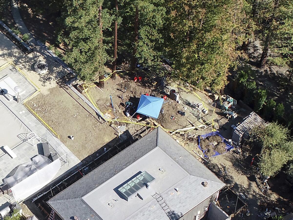 An aerial view of an investigation site next to a mansion